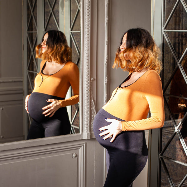 Pregnant female body wearing Jorgen House black high waist sports leggings and hazel colour long sleeve bodysuit