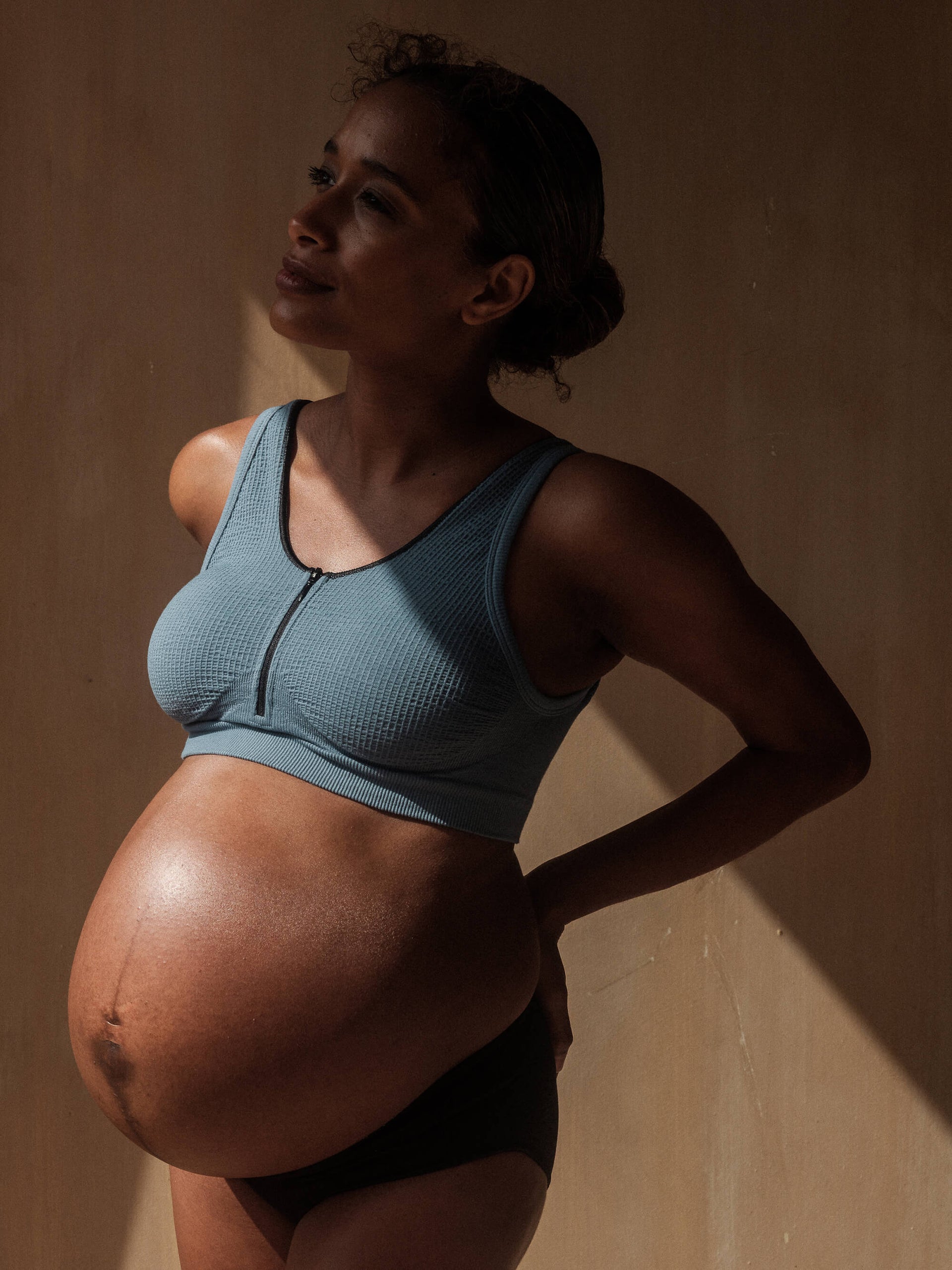 Jorgen House Blue zip front crop bra on pregnant female body