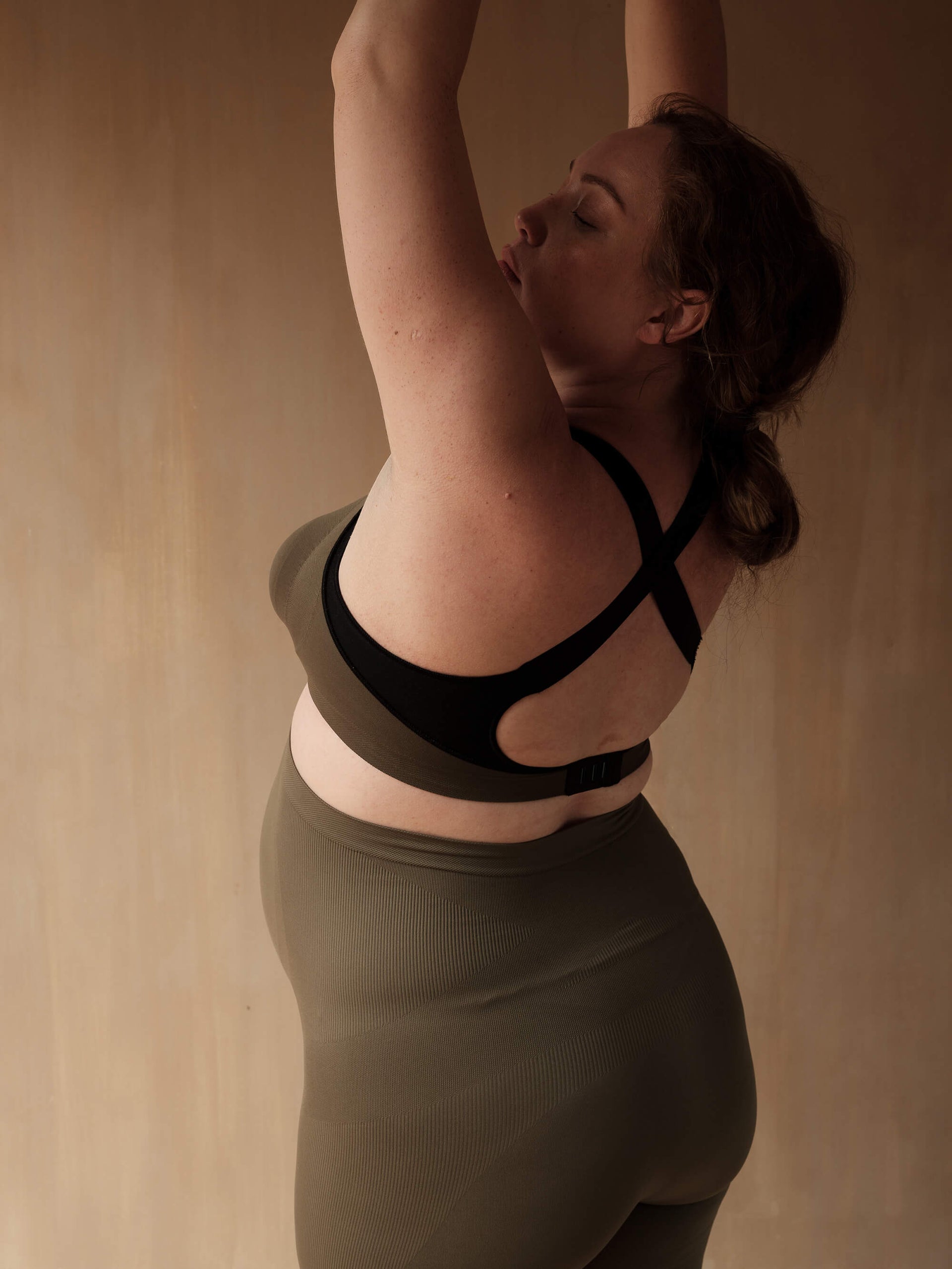 Jorgen House dark olive green maternity breastfeeding sports bra and high waist leggings on pregnant female body