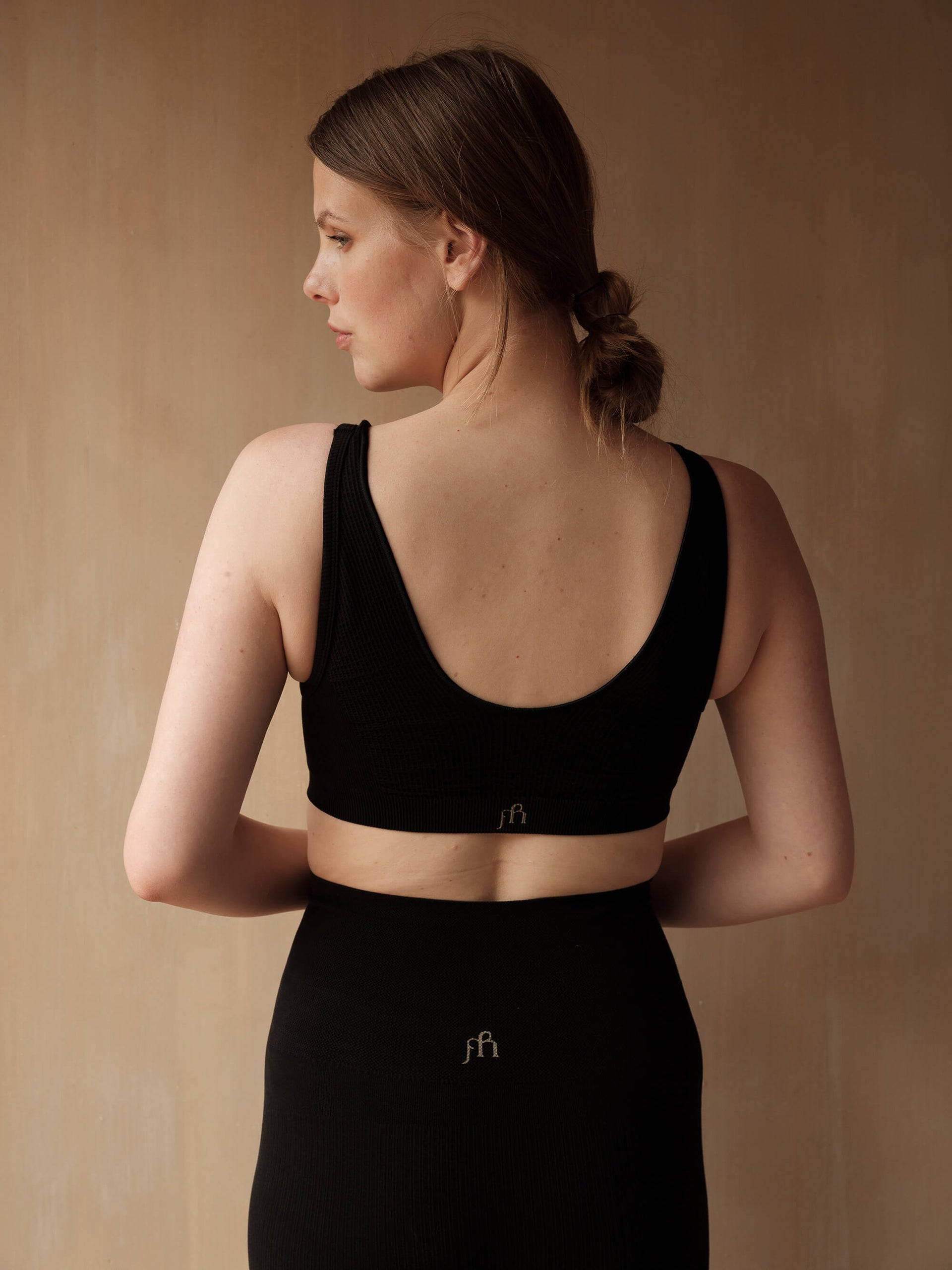 Jorgen House Black crop bra and high waist leggings on female body
