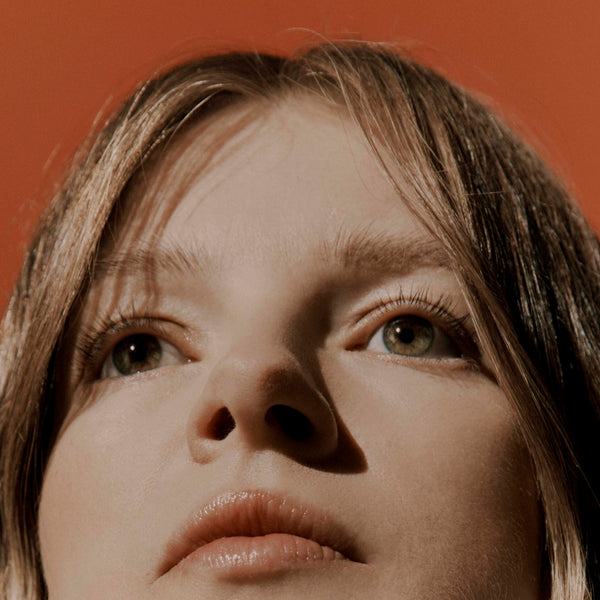 Female portrait shot on orange backdrop for Jorgen House 