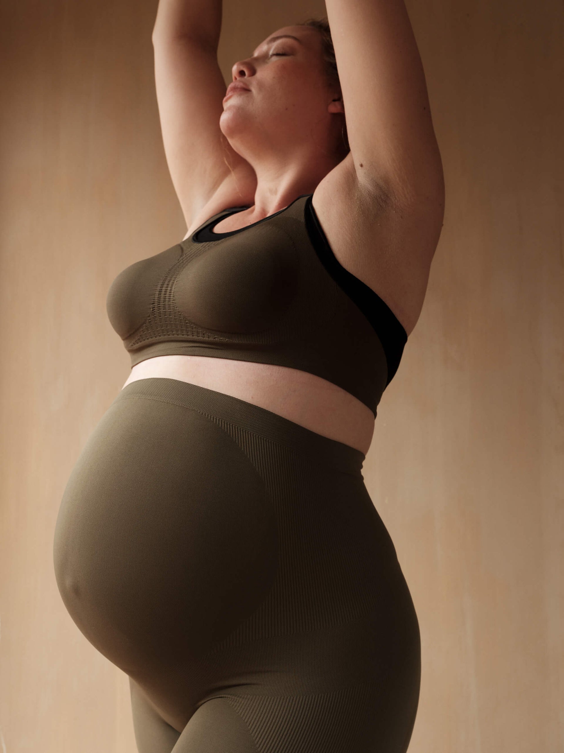 Jorgen House dark olive green maternity breastfeeding sports bra and high waist leggings on pregnant female body