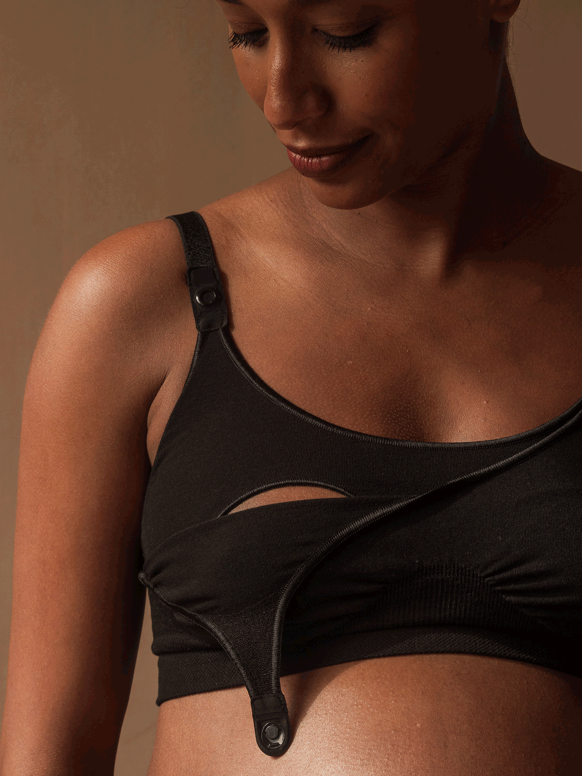 Jorgen House GIF showing a woman using the magnetic snaps on a black maternity breastfeeding bra