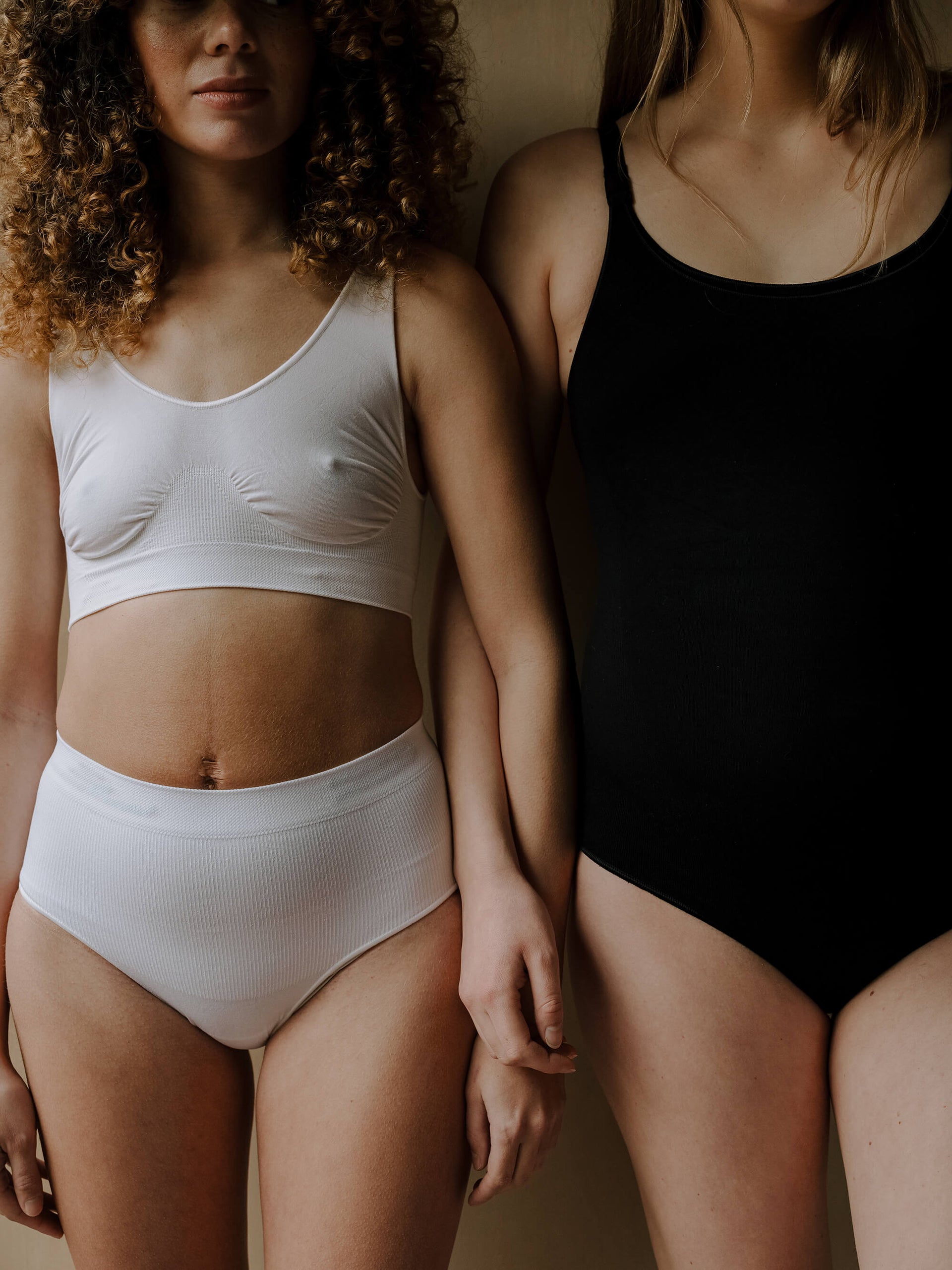 Jorgen House image of two women wearing white underwear set and black bodysuit