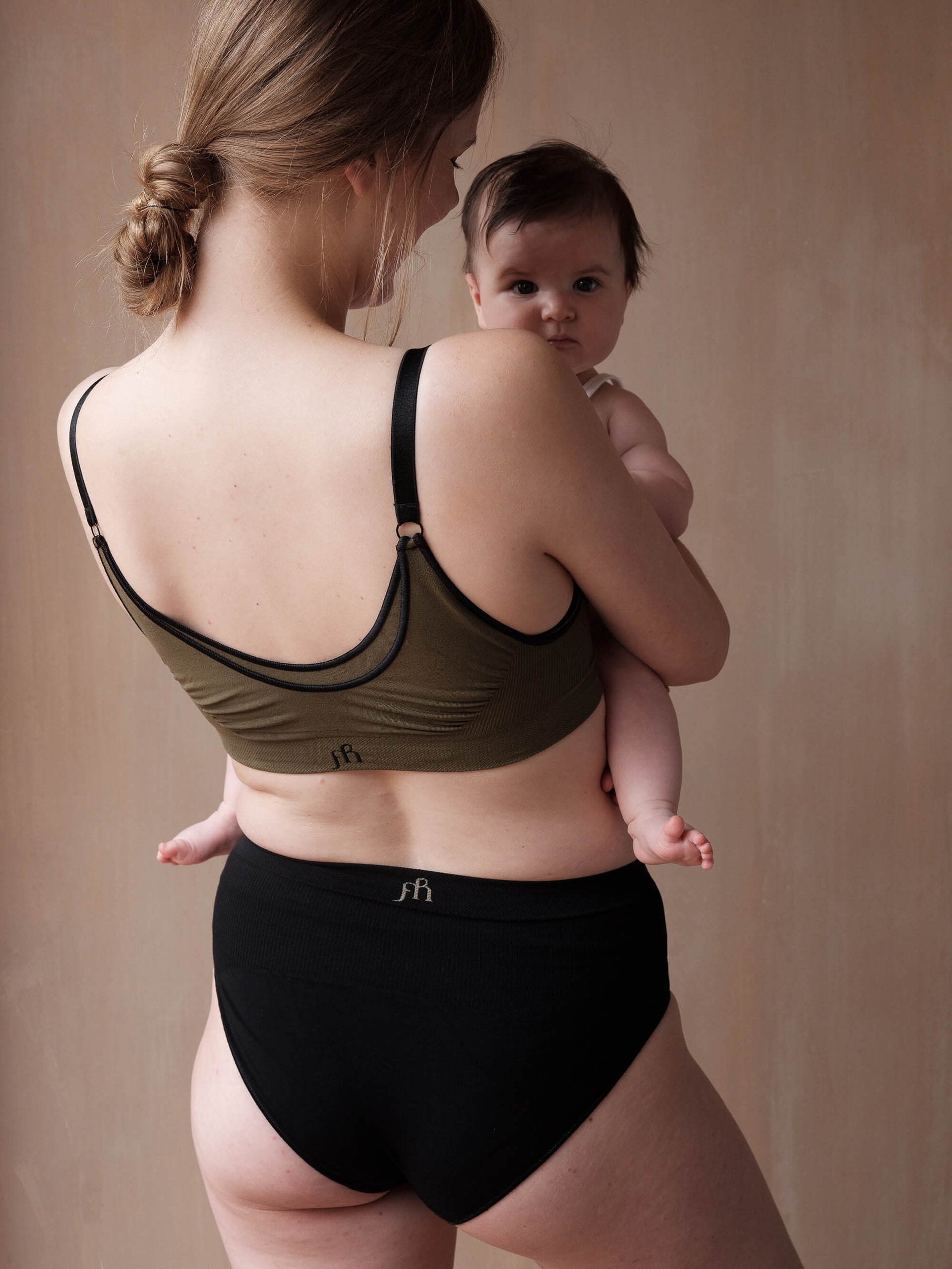 Jorgen House Dark olive green maternity breastfeeding bra and black briefs on. female body holding her baby