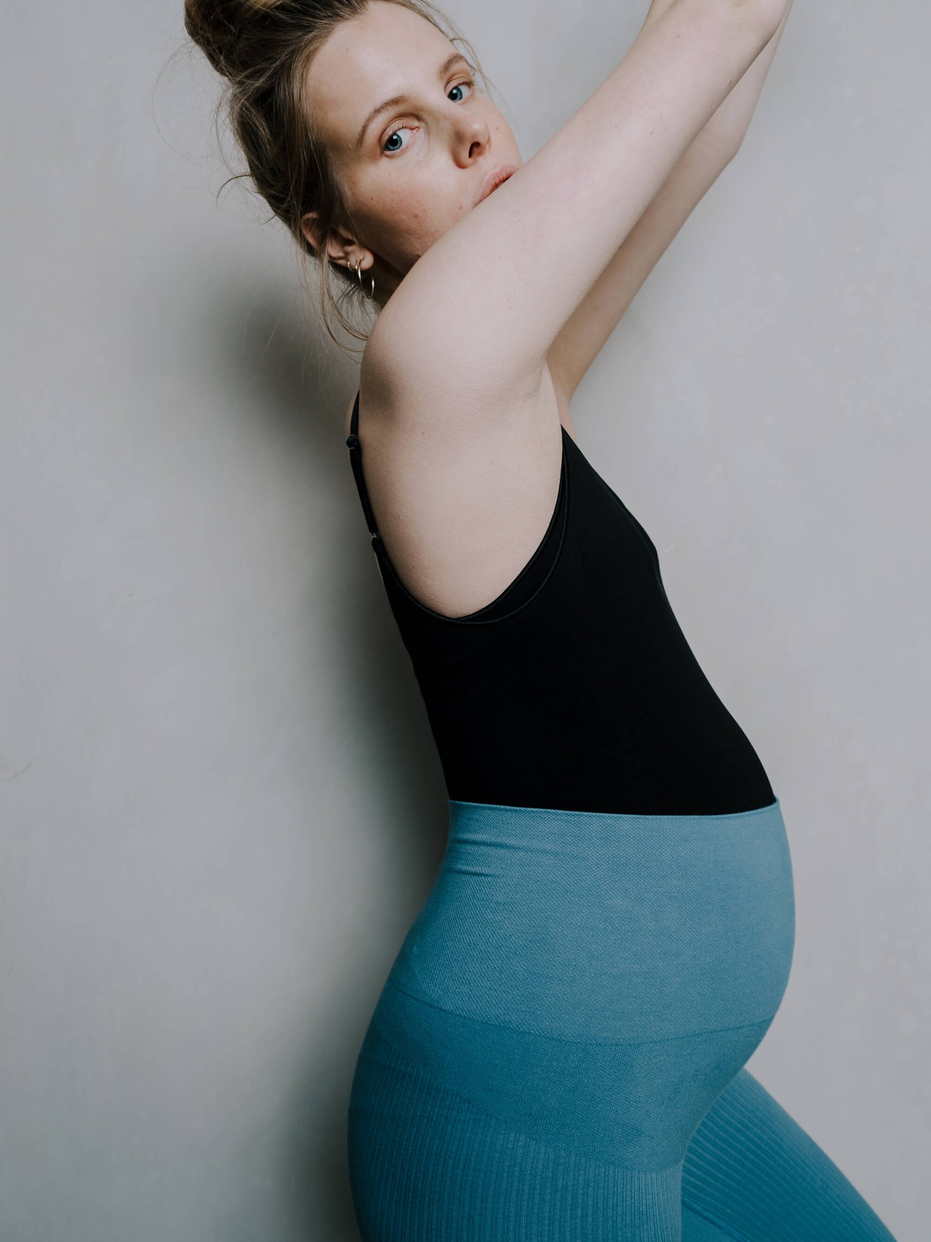 Jorgen House Blue colour high waist leggings and black bodysuit on pregnant female body