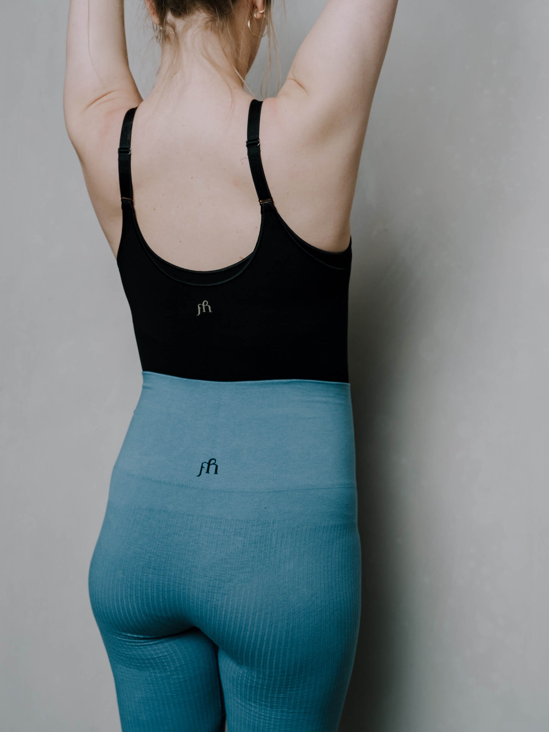 Jorgen House Blue high waist leggings and black strap bodysuit on female body