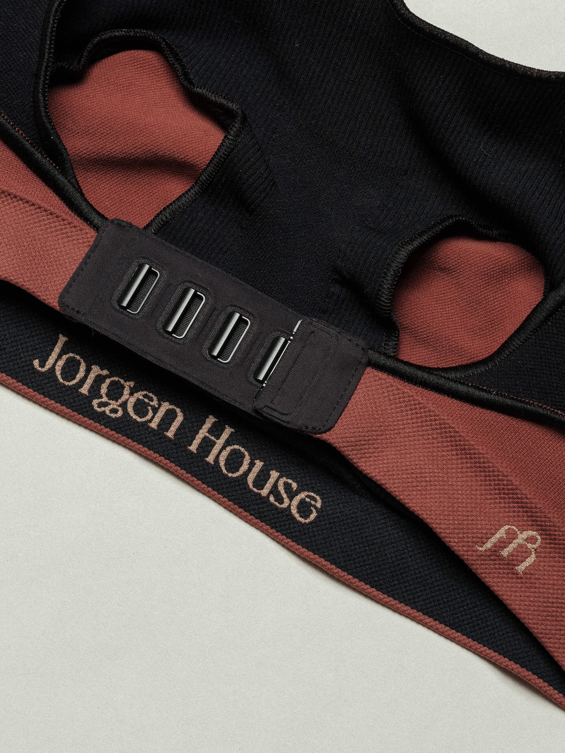 Jorgen House close up image of the brick red maternity breastfeeding bra back clasps